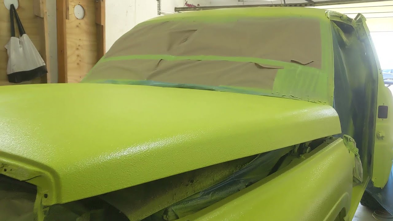 Spraying a ram 1500 with custom tinted Raptor Liner