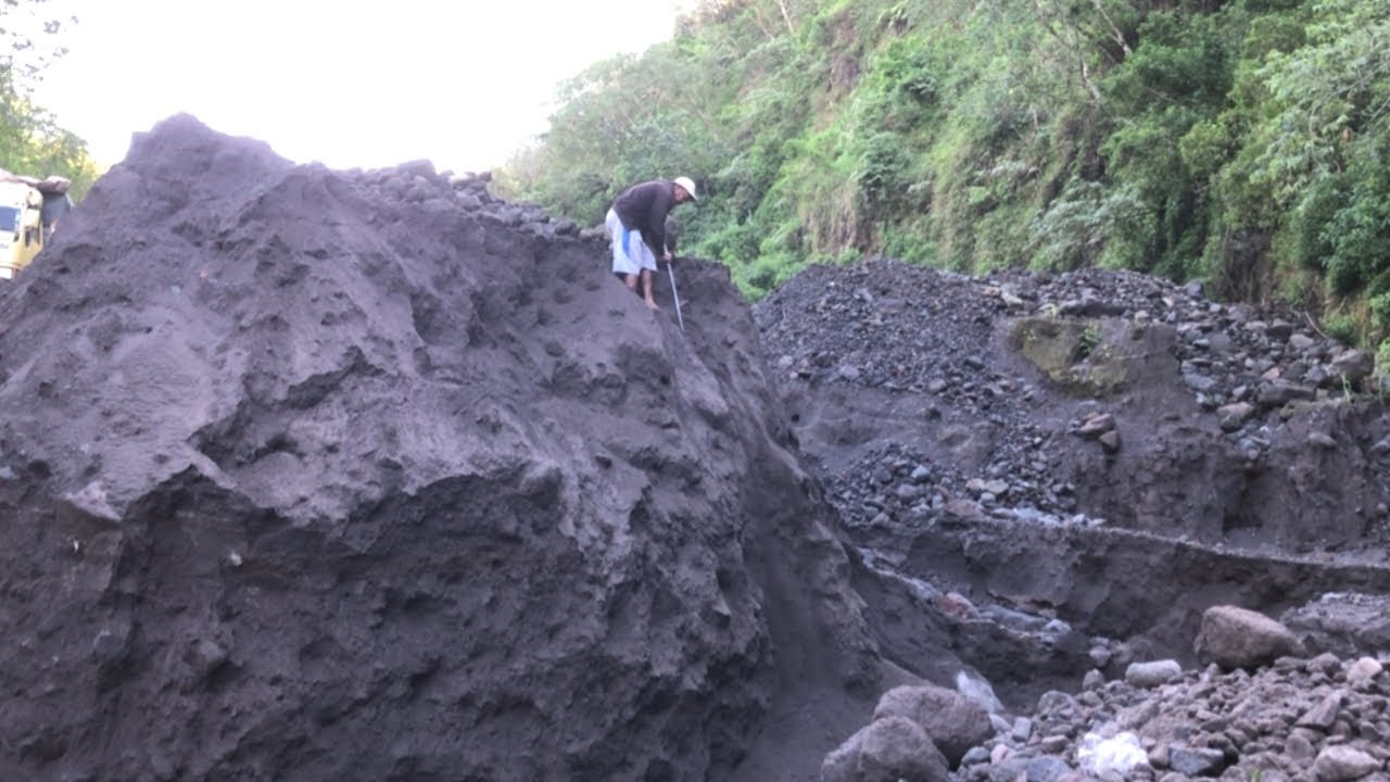 One miner eagerly searches for sand alone