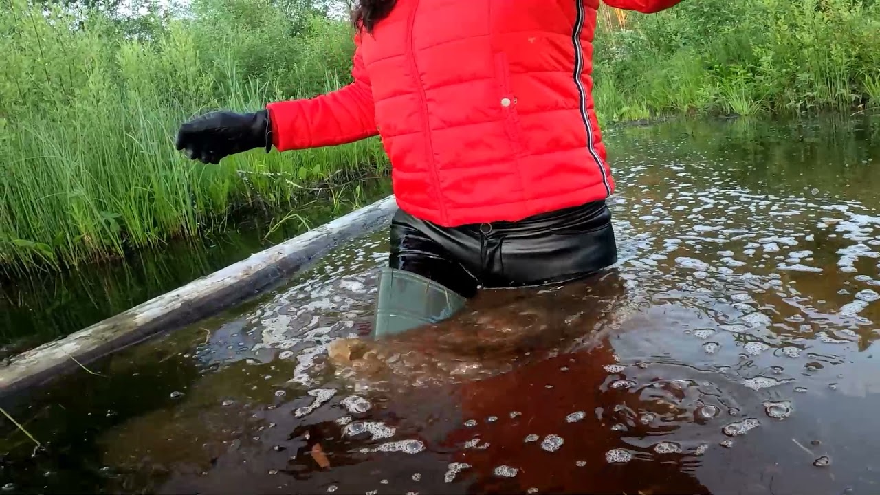 Wet waders and wet leather pants in deep mud