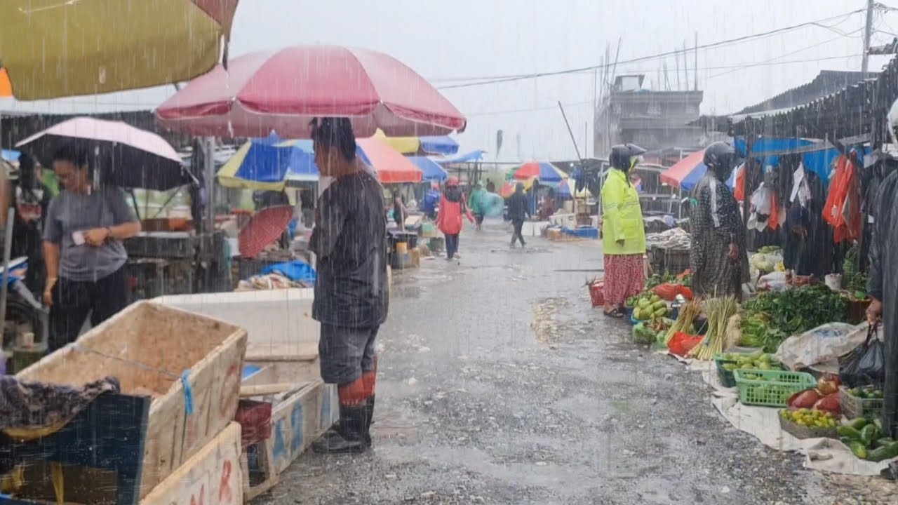 Walking in the middle of heavy rain at a traditional Indonesian market