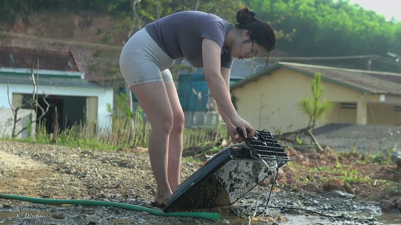 The chubby little girl successfully repaired the television that was buried deep in the mud.