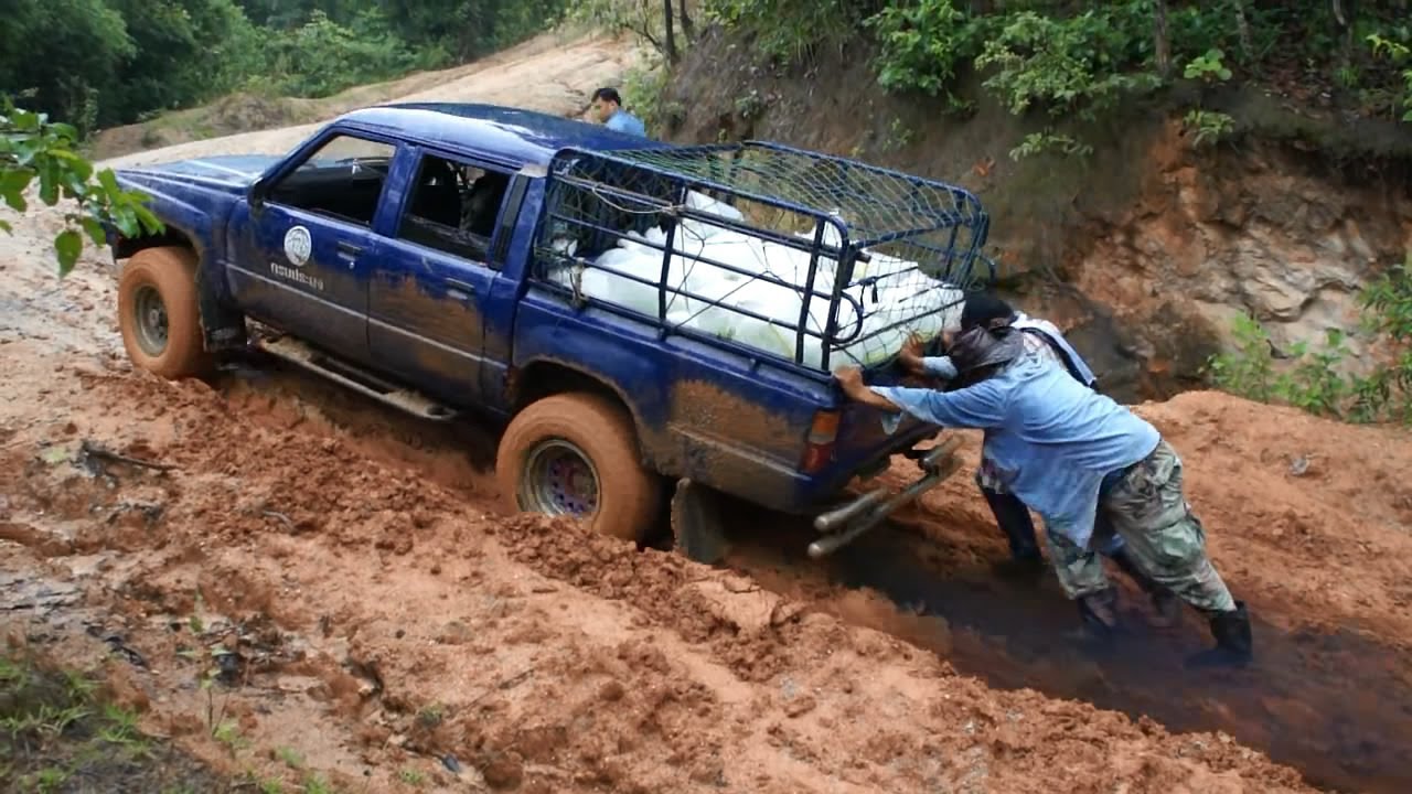 Ford Ranger and Toyota Hilux On Muddy Climbing Route - Pickup Truck On Mud Track