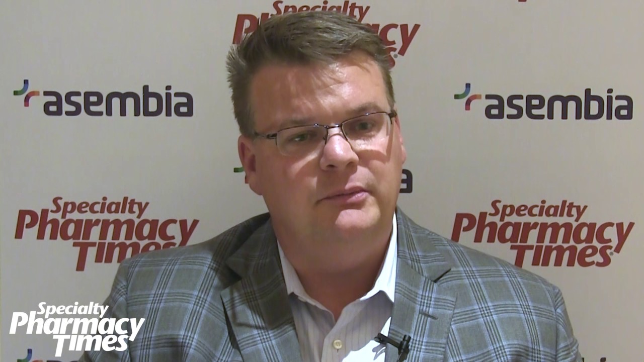 How can a Specialty Pharmacy Linked to a Retail Pharmacy Reduce Drug Costs?
