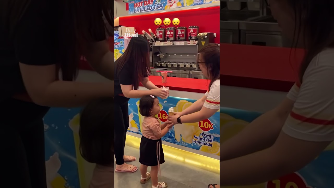 Cheeky girl steals a bite of stranger&rsquo;s ice cream