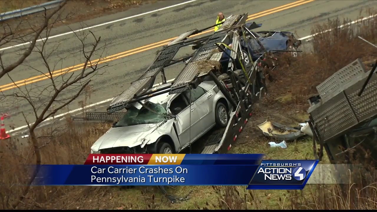 Car carrier goes off Pennsylvania Turnpike, leaving vehicles strewn across hillside