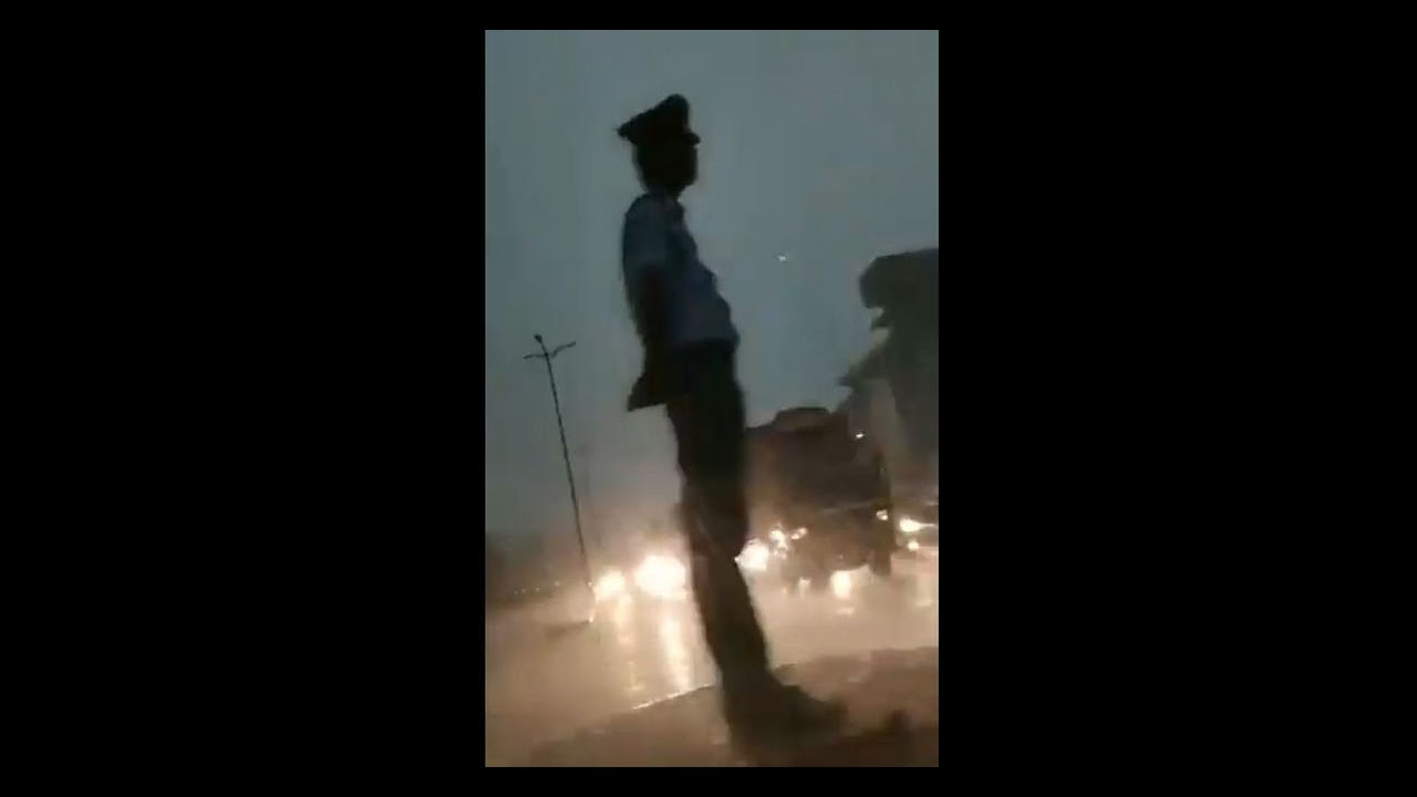 Assam cop wins hearts, stands on duty amid rainstorm
