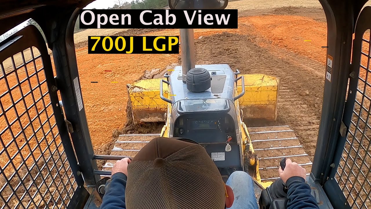 Open cab view of 700j finishing house pad and driveway. 