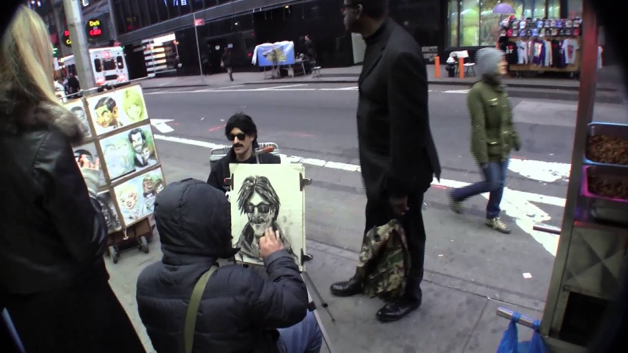 Banksy getting portrait drawn in Times Square NYC