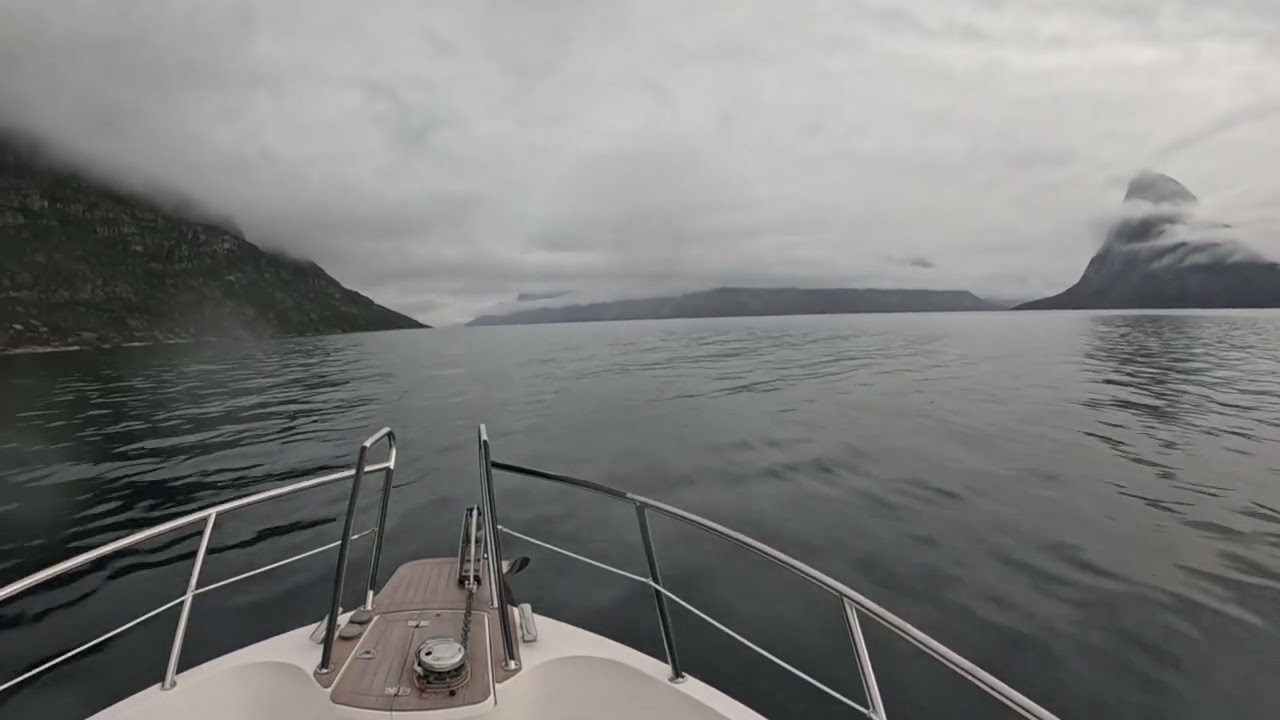 Boating Greenland. Cloudy journey in the fjords by Nuuk.
