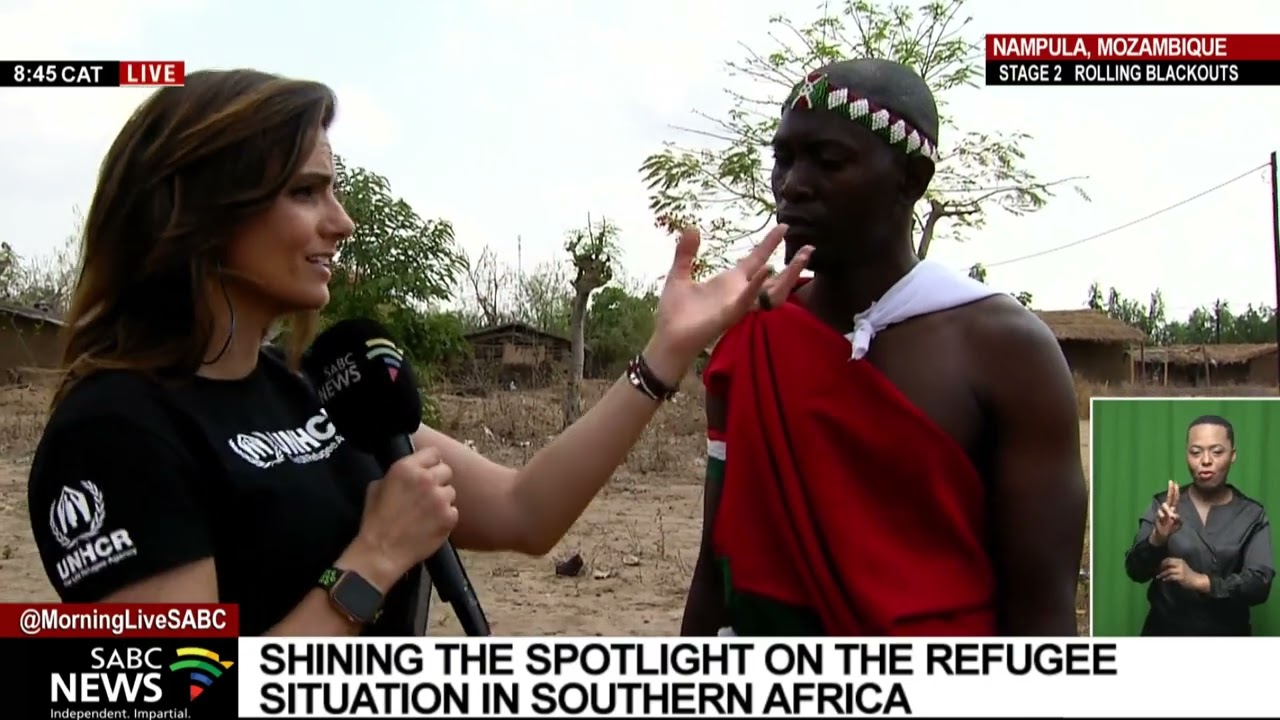 SABC News anchor Leanne Manas speaks to a refugee at a Mozambique settlement