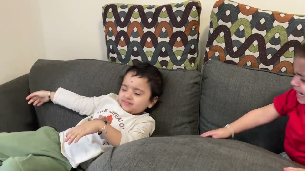 Florra and Dilsher throwing sofa cushions