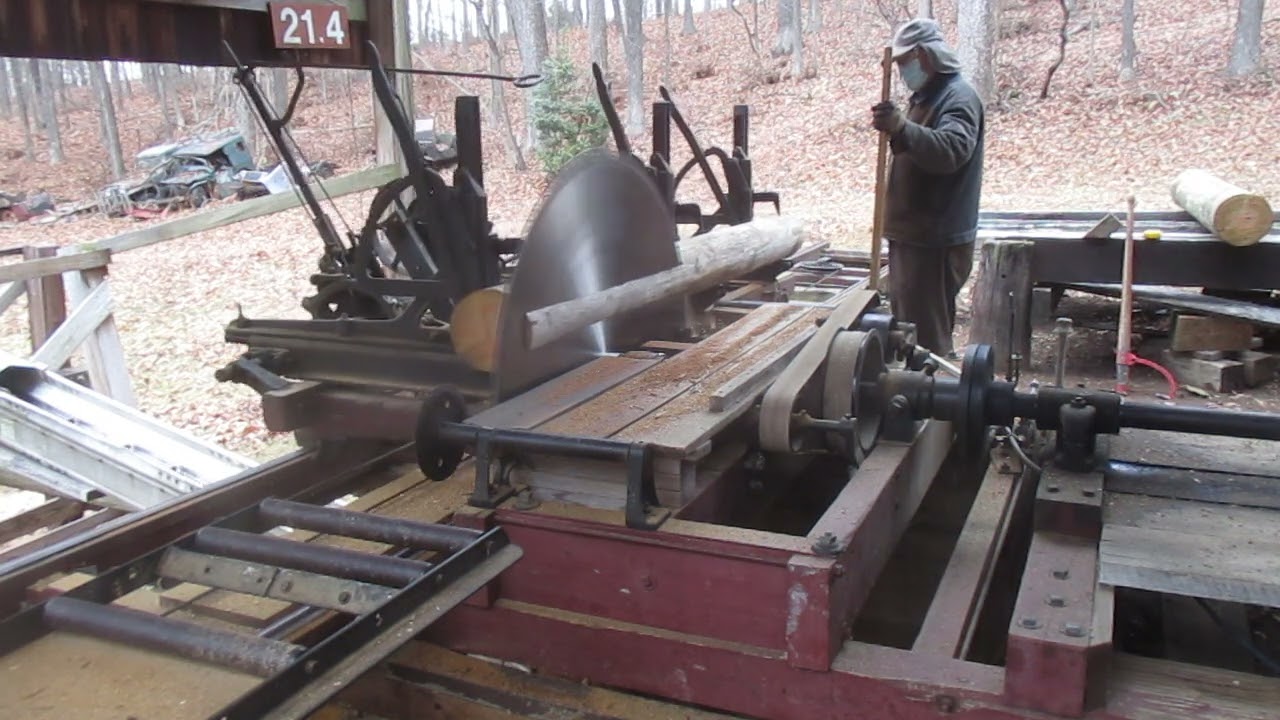 Sawing old utility poles on a old FRICK Sawmill # 1689