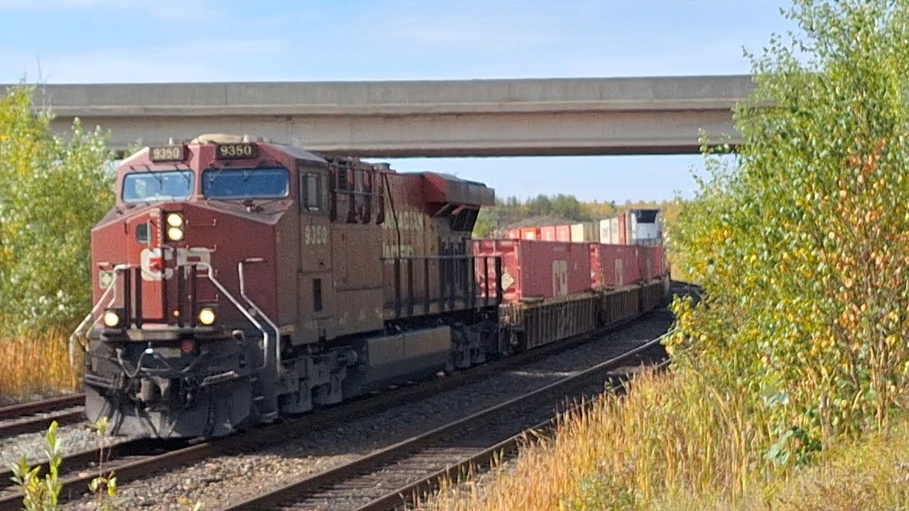 CP ES44AC 9350 leads intermodal train with interesting cars at the end