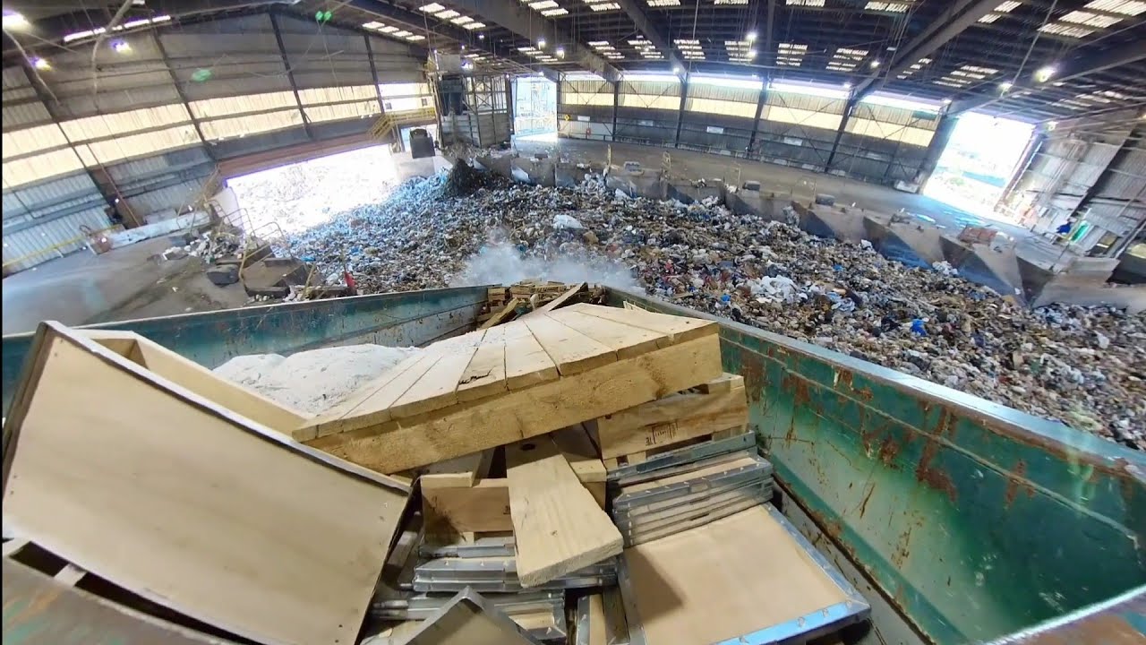 Waste Management garbage trucks dumping at transfer station