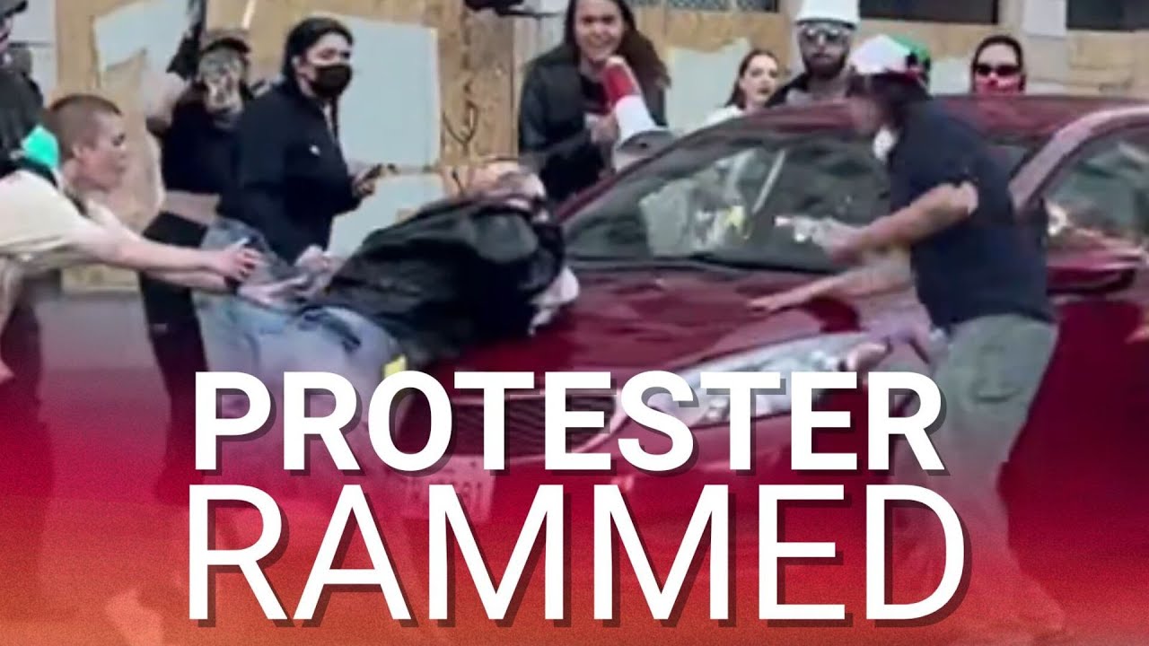 Protester run over by moving car as fed-up LA drivers have had enough of disruptive riots