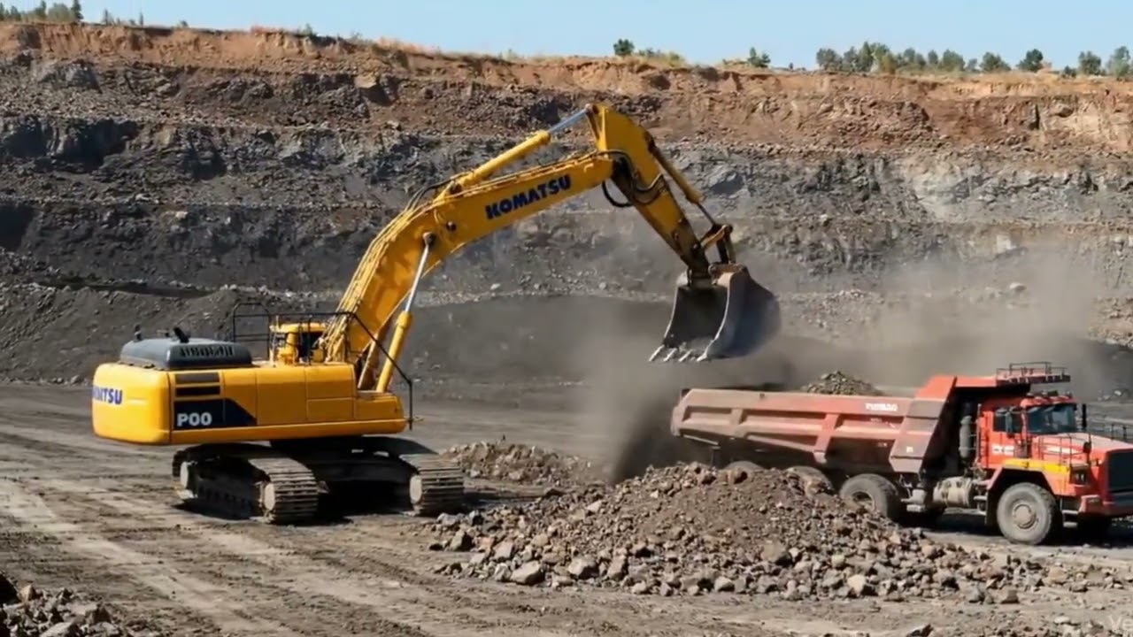 Komatsu PC1250 Excavator Loading Dump Trucks in Open Pit Iron Ore Mine