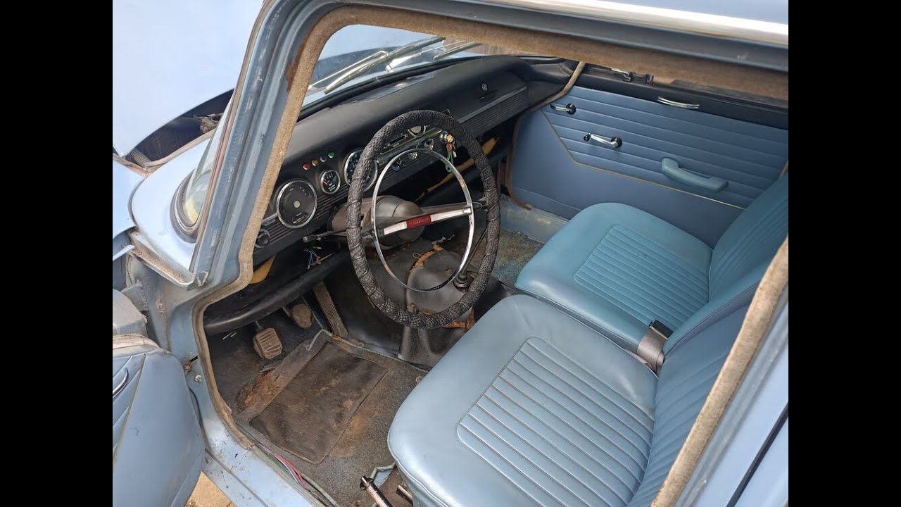 Two Men Try and Fit a Windscreen Rubber To a Hillman Super Minx