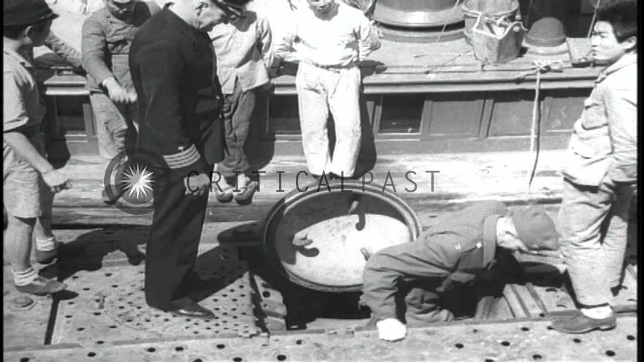 Admiral Robert M Griffen and others aboard captured Japanese submarine. HD Stock Footage