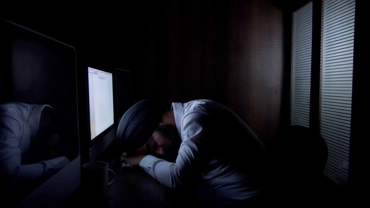 Young Indian office employee sleeping on the desk, working lat... | Indian Stock Footage | Knot9
