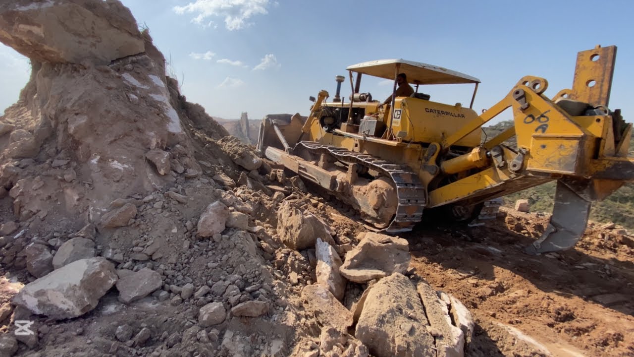 Horrible job! CATERPILLAR D8K Bulldozer Working On The Top Of Mountain And Falling Big rocks