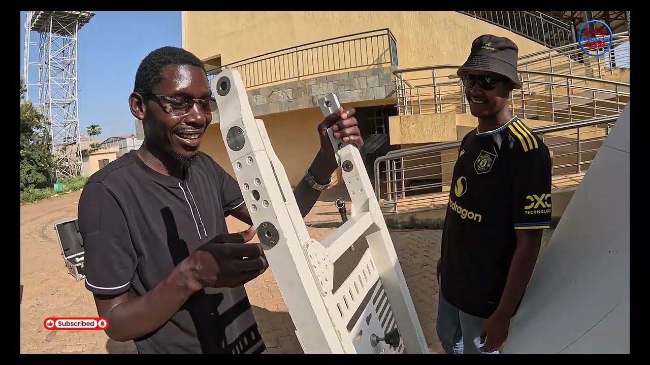 Broadcast engineer setting up the satellite system for a live tv football production