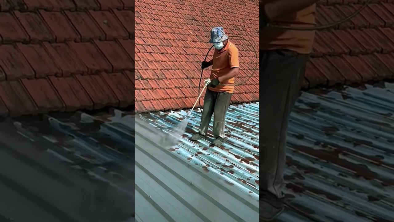 The process of painting a roof using a powerful sprayer