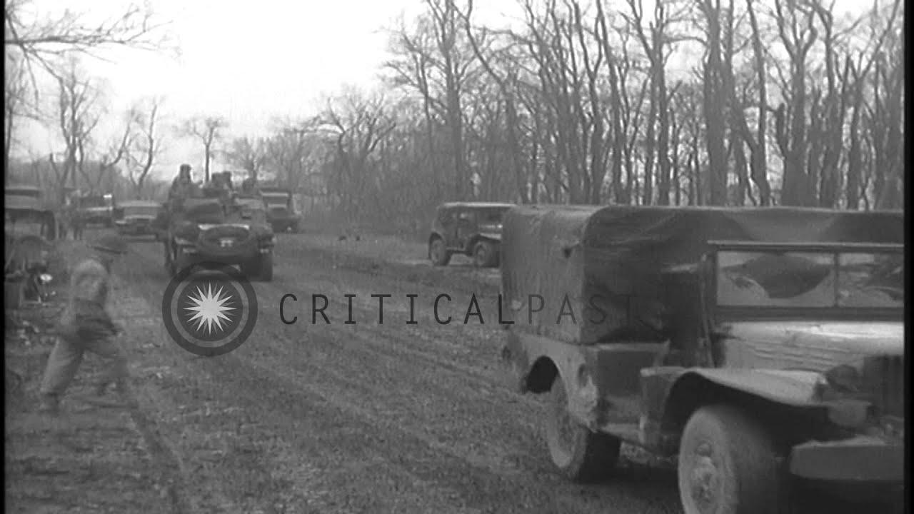 Signal Corps linemen stringing wires to poles and other soldiers standing on stre...HD Stock Footage