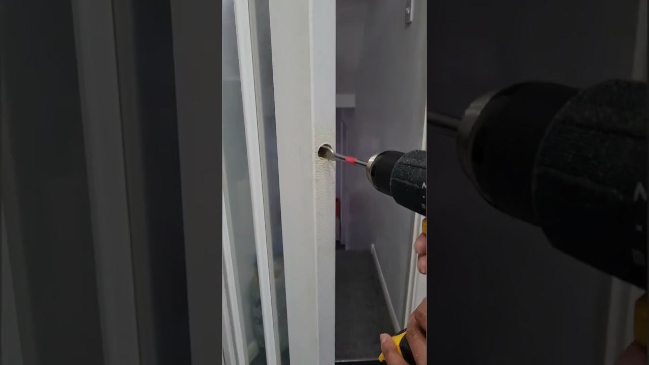 How to drill hole for the door handle by using coloured tape around drill machine for guide