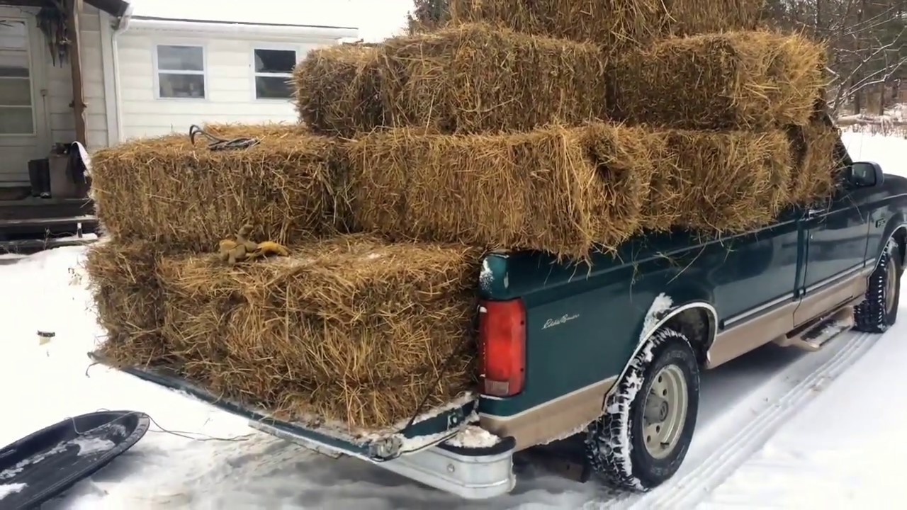 Insulating around a home with bales of hay or straw