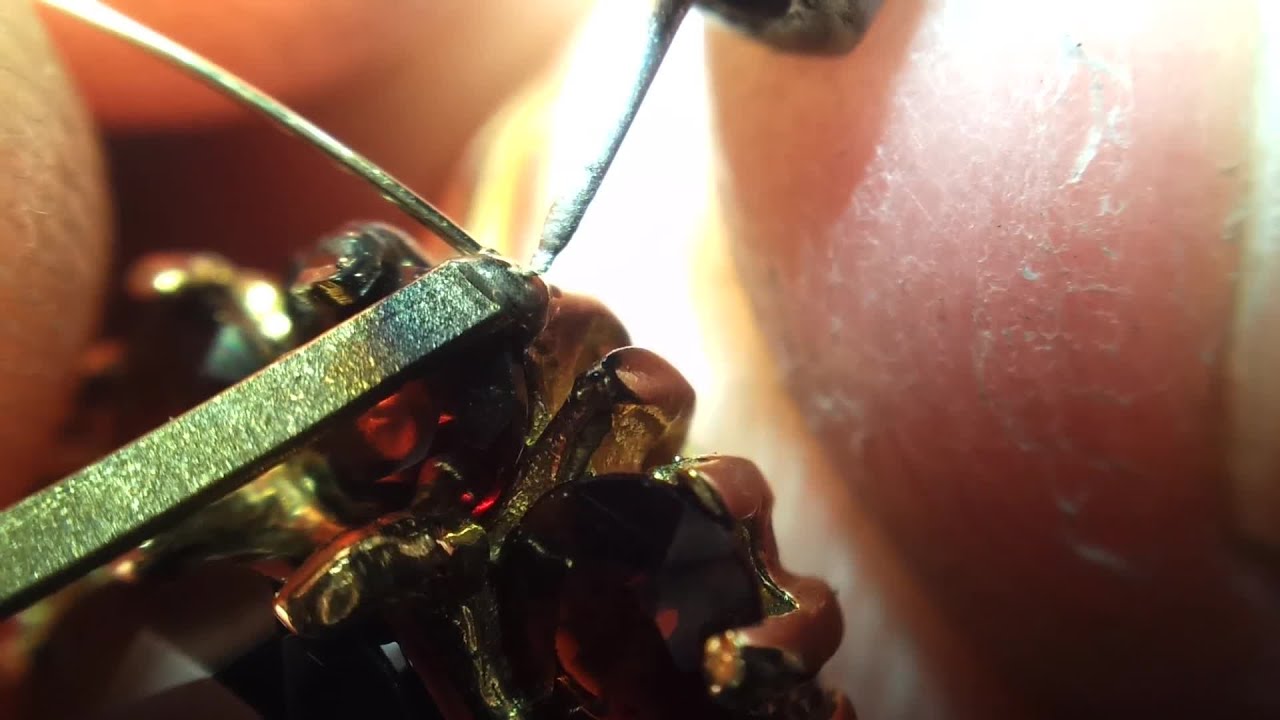 Weld retip 3 claws on a garnet cluster ring