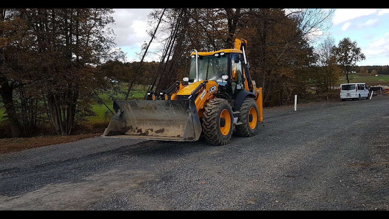 JCB 4cx backhoe loading a truck with forks