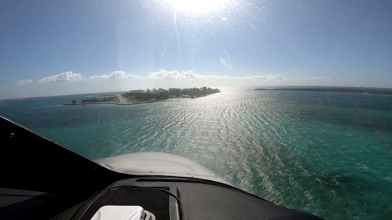 Britten Norman Islander BN2 crosswind landing and take off, private island Little Whale Cay Bahamas.