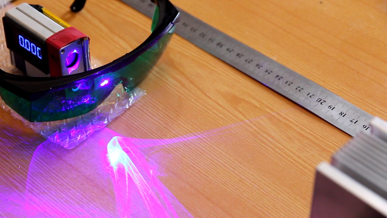 Comparison 4 types of protective laser goggles. Real experiment