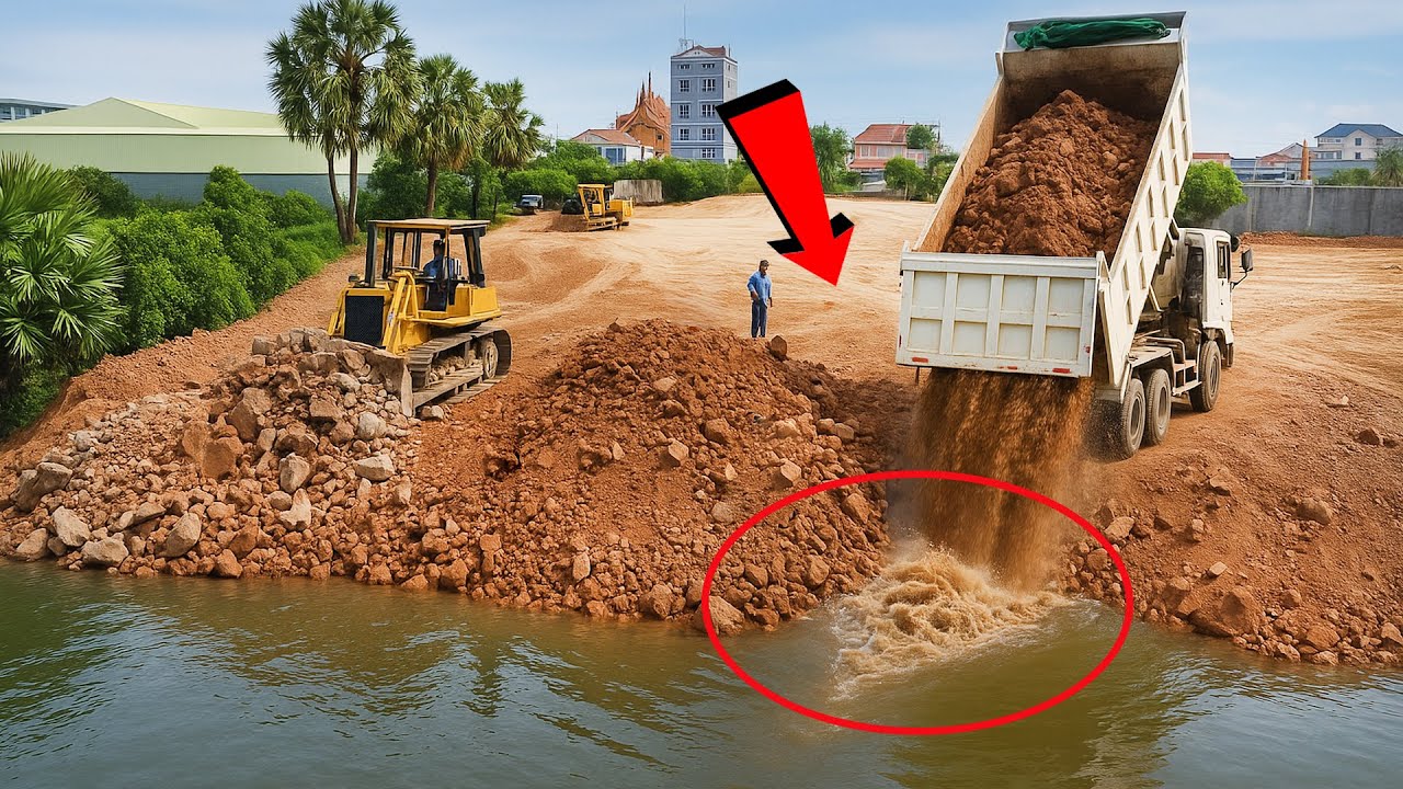 25-Ton Truck Delivers Material as KOMATSU Bulldozer Builds Lake Road