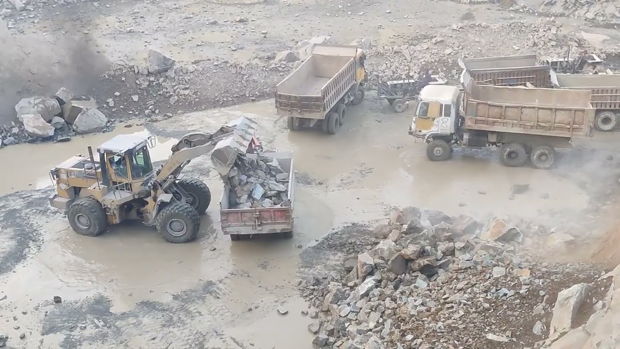 Dumper & Trolley loading Stone with Caterpillar Loadar in mountain