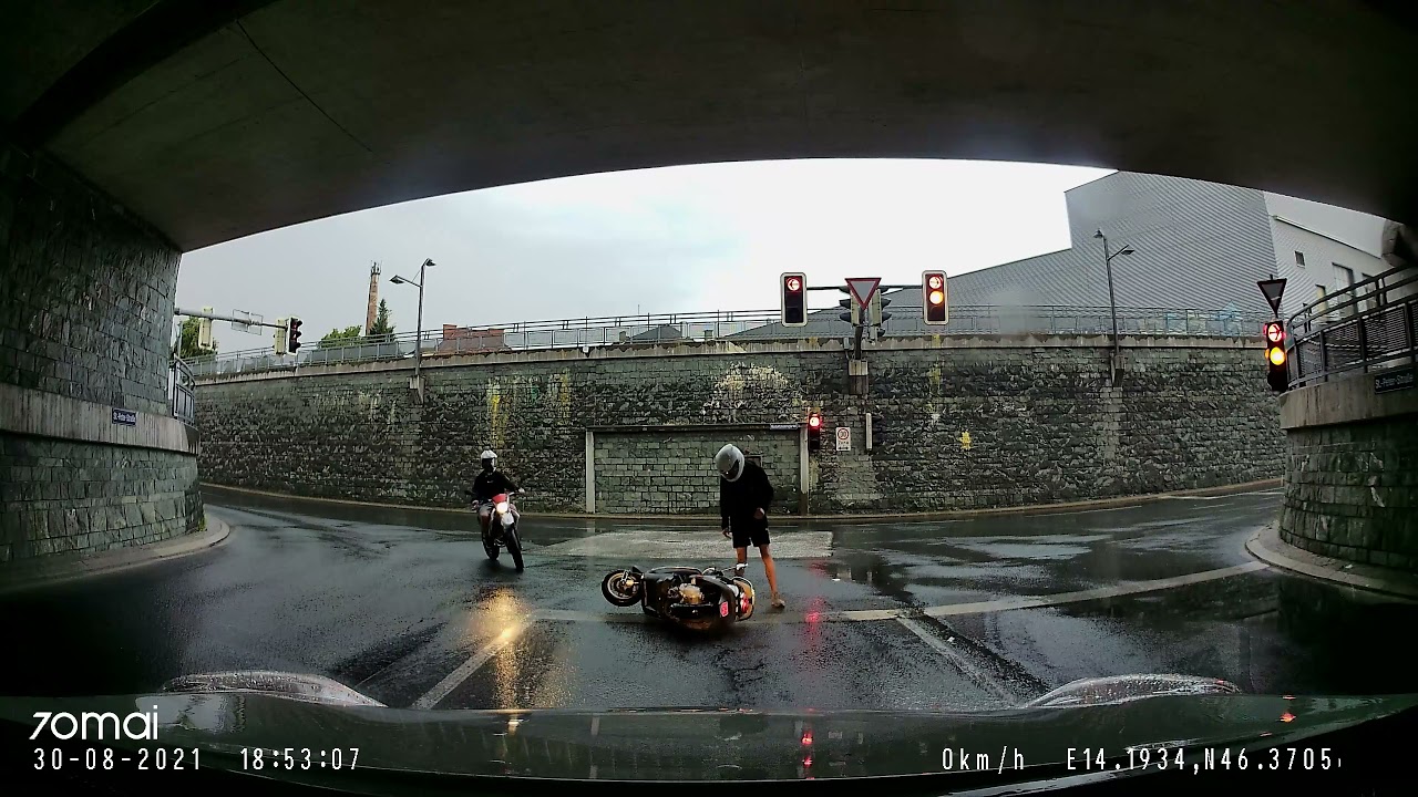 Fall of a mopedist when turning on wet asphalt. St.Peter-Straße, 9020 Klagenfurt.Austria. 30.08.2021