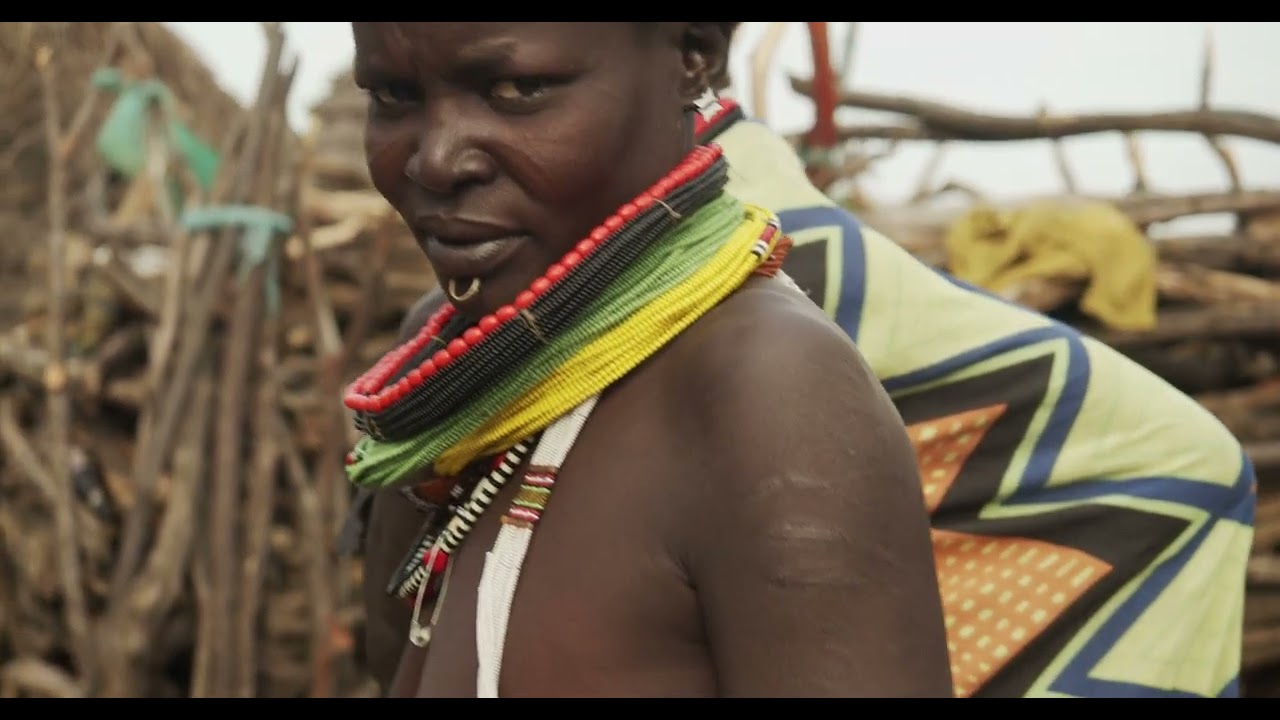 Toposa tribe woman in traditional clothing in a village, Namorunyang State, Kapoeta, South Sudan