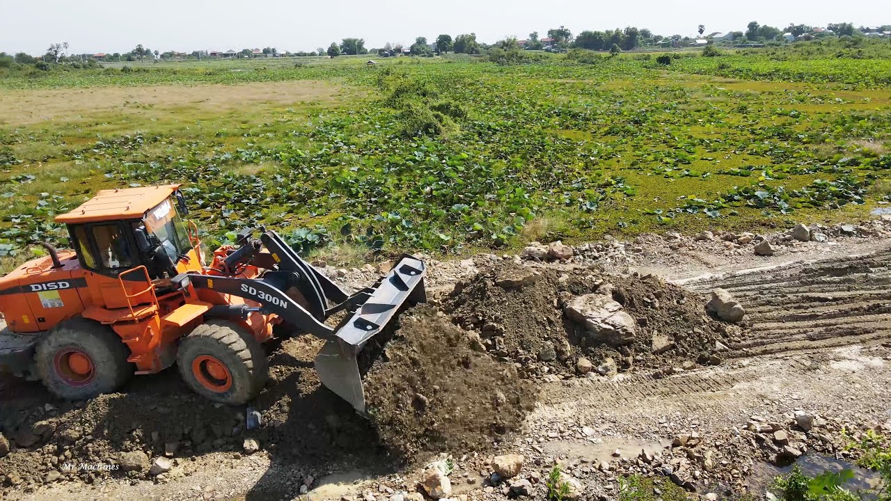 Big Heavy DISD SD300N Wheel Loader Pushing Gravel Rock Building New Road Across Huge Lake