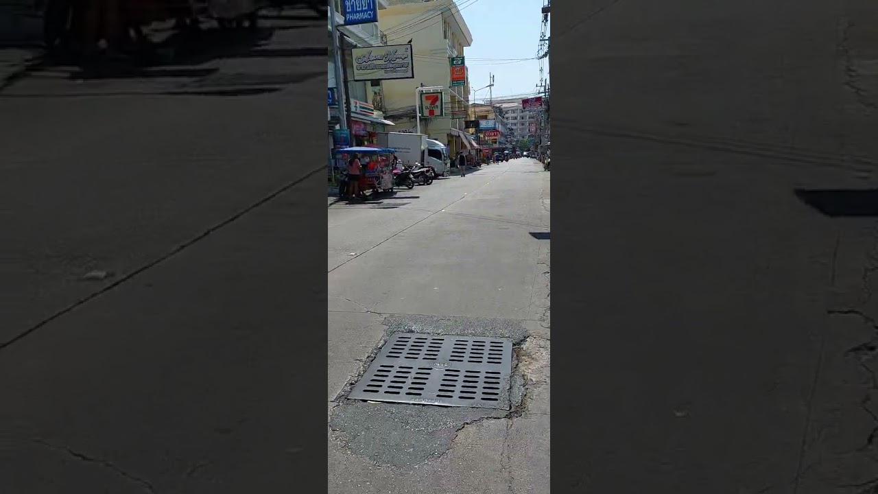 WALKING DOWN SOI BUAKOW IN CENTRAL PATTAYA DURING A HOT DAY IN FEBRUARY.