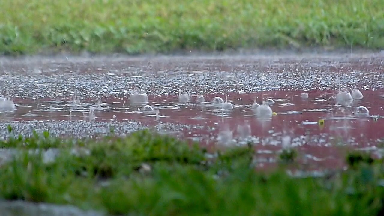 Rain drops falling on the ground in slow motion - 4K HD