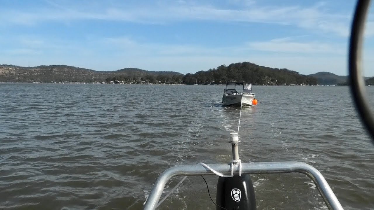 Towing a boat astern with another boat