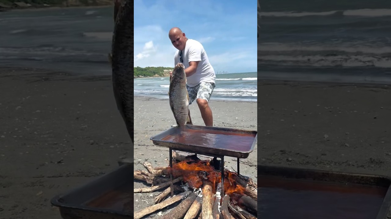 fritando peixe gigante inteiro na beira do mar