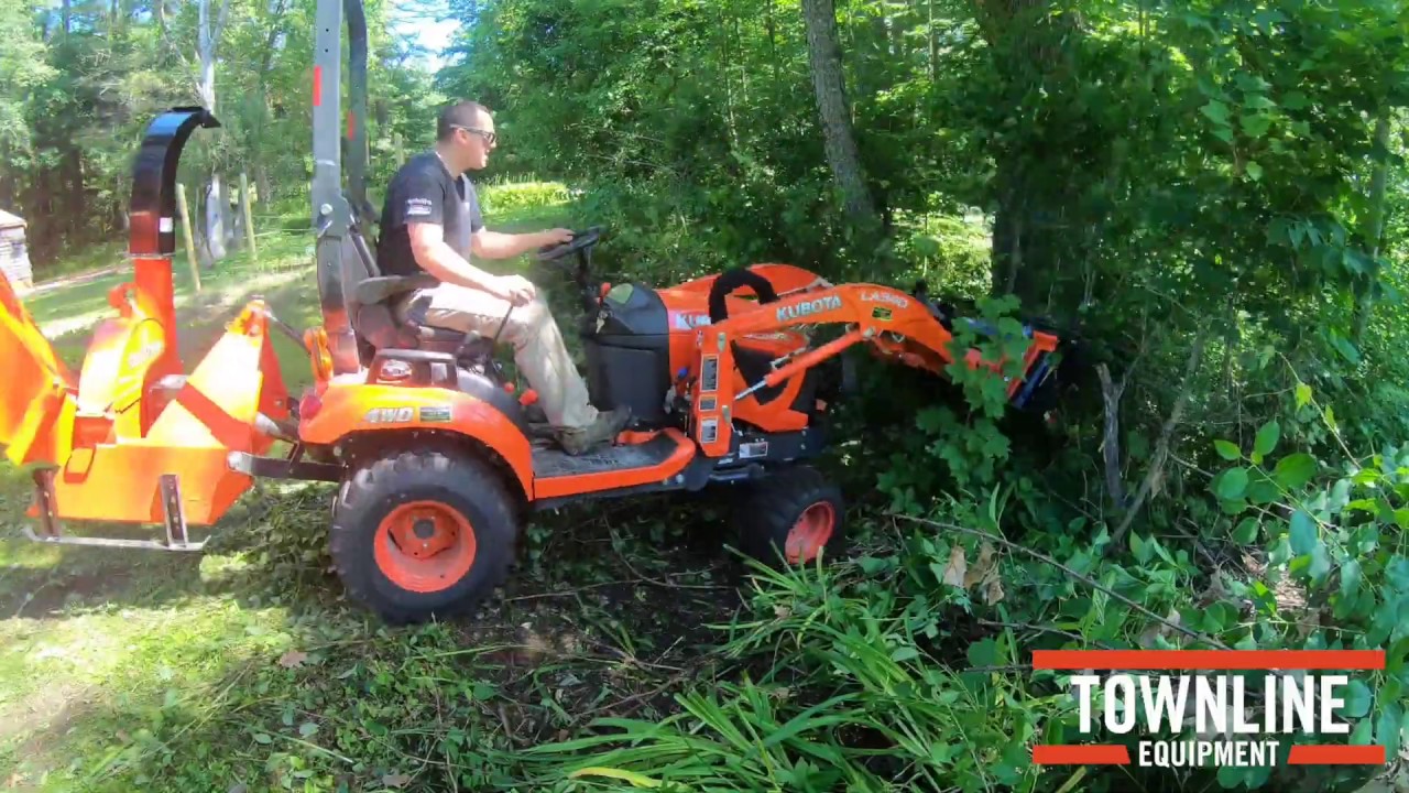 Kubota BX23s Compact Tractor Cleaning Up Brush with Land Pride Grapple and Land Pride Chipper