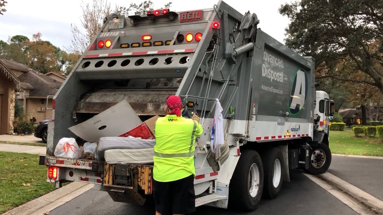 Advanced Disposal Rear Loader Garbage Truck on Manual Trash with Mattress Packing