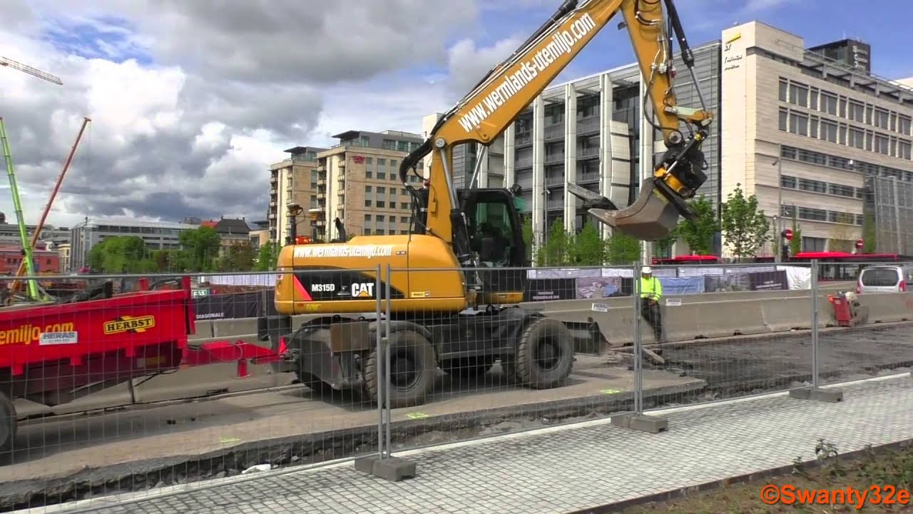 Caterpillar M315D Digging Up Asphalt