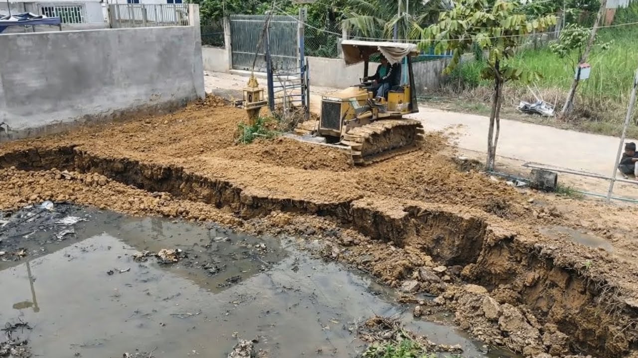 Small Bulldozer And 5T Dump Trucks Filling Land In School At Village