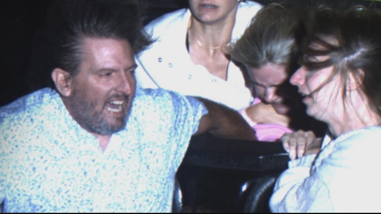 Adults Hold On To Girl In Danger Of Being Swept Out Of Roller Coaster