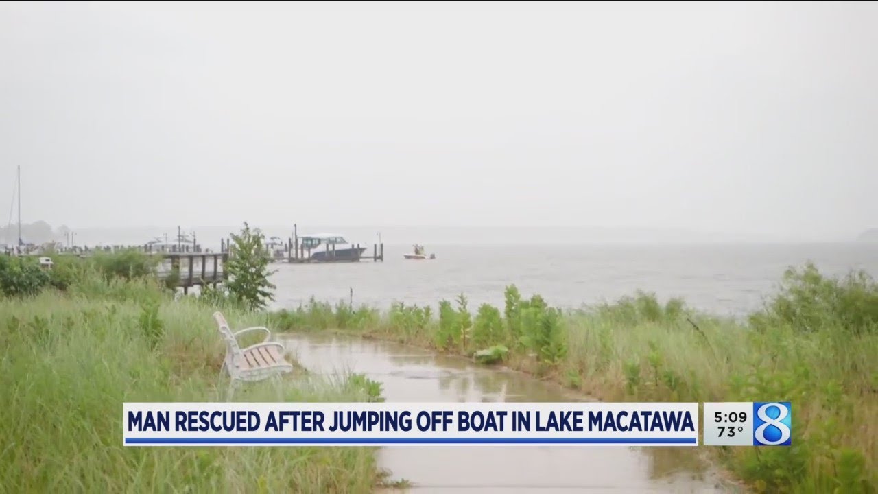 Man struggling in water pulled out of Lake Macatawa by friends