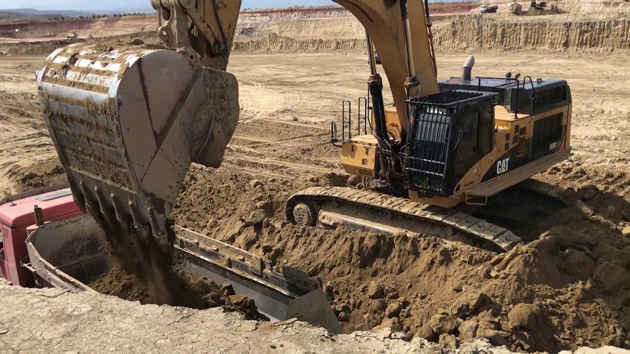 Caterpillar 365C Excavator Loading Trucks With Three Passes