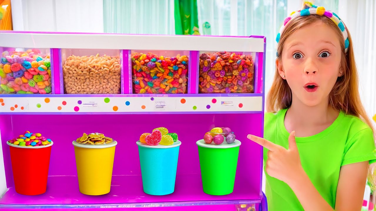 Nastya et papa jouent avec des bonbons et un distributeur de fruits